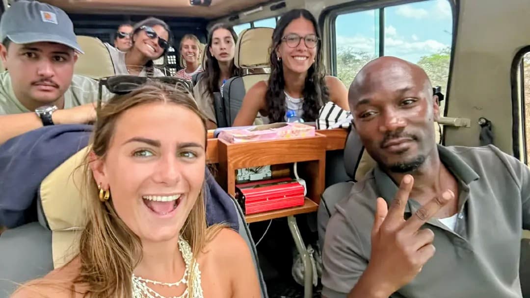Guests and guide on a safari vehicle